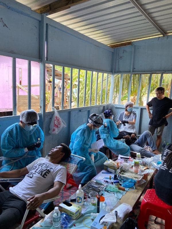 Volunteer dentists treating patients at a mobile dental clinic